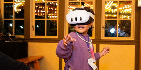 A young girl with a VR headset on